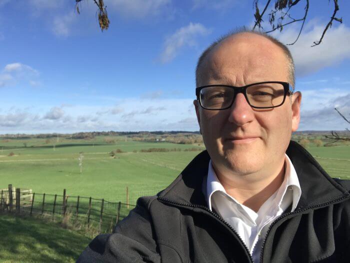 David Roberts shares his thoughts on the move from fossil fuels to a cleaner, healthier environment. Image shows David Roberts, MD of Nu-Heat, with a fresh blue and green spring countryside image behind him.